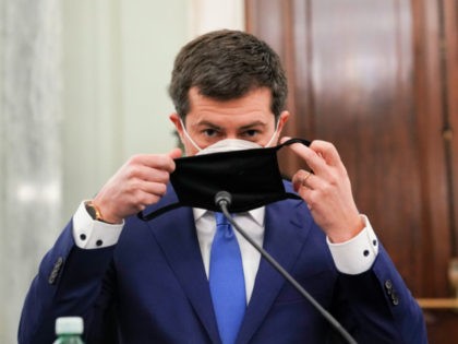 Pete Buttigieg, U.S. secretary of transportation nominee for U.S. President Joe Biden, puts on a protective mask during a Senate Commerce, Science and Transportation Committee confirmation hearing on January 21, 2021 in Washington, D.C. Buttigieg, is pledging to carry out the administration’s ambitious agenda to rebuild the nation’s infrastructure, calling …