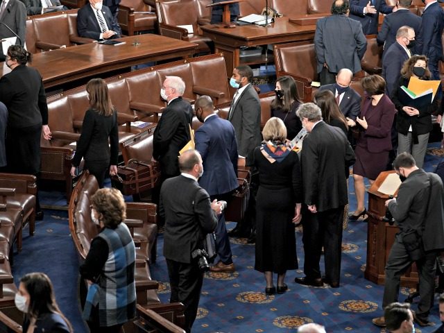 WASHINGTON, DC - JANUARY 06: Senators and Senate clerks leave to debate the certification of Arizona's Electoral College votes from the 2020 presidential election during a joint session of Congress on January 6, 2021 in Washington, DC. Congress held a joint session today to ratify President-elect Joe Biden’s 306-232 Electoral …