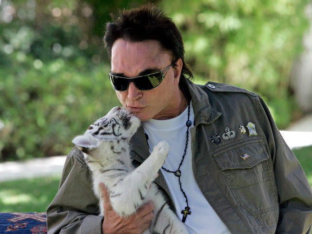 Roy Horn, of the illusionist team of Siegfried & Roy, kisses a six-week-old white-striped