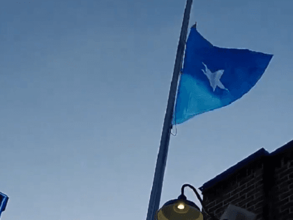 Somali flag flying over Holiday gas station where police shot and killed a convicted felon. (Twitter Video Screencapture/Shane B. Murphy)