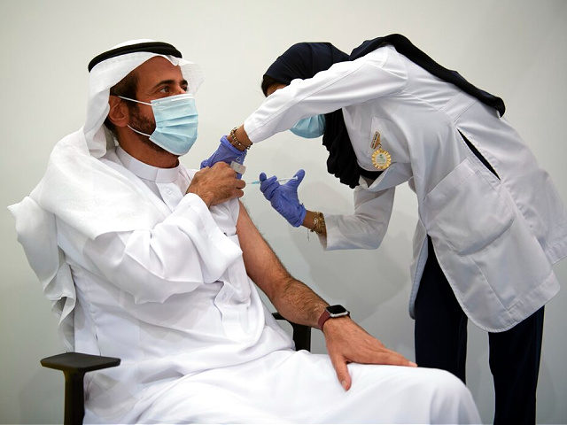 In this photo released by Saudi Health Ministry, Tawfiq Al-Rabiah, Saudi minister of health, receives one of the first COVID-19 vaccinations in Riyadh, Saudi Arabia, Thursday, Dec. 17, 2020. (Saudi Health Ministry via AP)