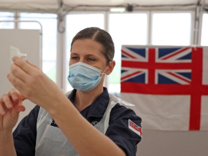 Royal Navy medics prepare syringes ahead of giving injections of the Oxford/AstraZeneca Co