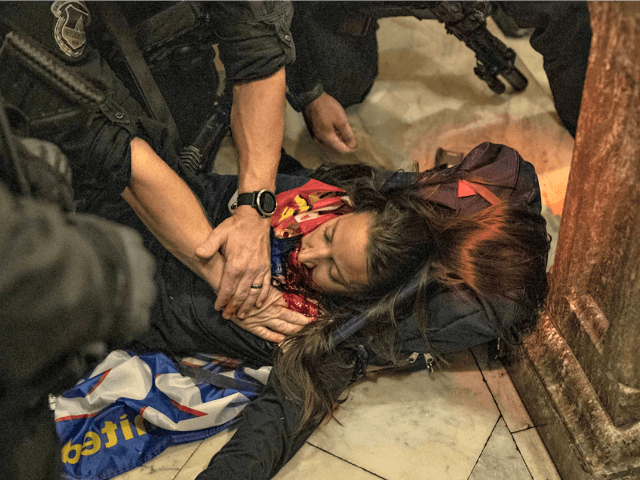 A woman is wounded on the ground after being shot during a protest at the U.S. Capitol today. Victor J. Blue/Bloomberg via Getty Images