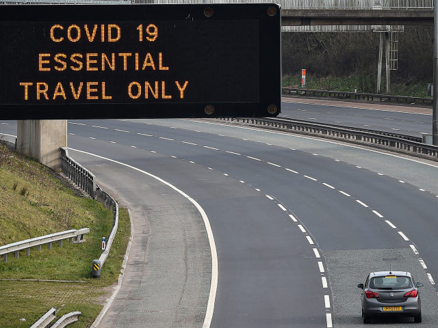 GLASGOW, SCOTLAND - MARCH 24: A motorway sign on the M8 motorway advising on essential travel only on March 24, 2020 in Glasgow, Scotland. First Minister of Scotland Nicola Sturgeon along with British Prime Minister, Boris Johnson, announced strict lockdown measures last night urging people to stay at home and …