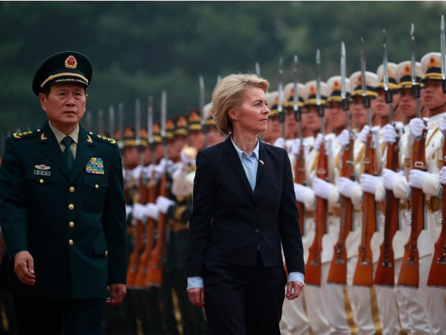 German Defense Minister Ursula von der Leyen (C) and China's Minister of National Defense General Wei Fenghe (L) review honour guards during a military honours ceremony at the Bayi building in Beijing on October 22, 2018. (Photo by HOW HWEE YOUNG / POOL / AFP) (Photo credit should read HOW …