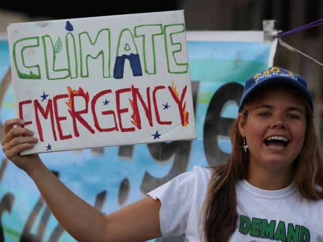 CORAL GABLES, FLORIDA - JANUARY 17: Nicole Level holds a sign that reads, ' climate emergency', as she joins with others to call for action to combat climate change as wildfires rage in Australia on January 17, 2020 in Coral Gables, Florida. The protest was a call to action and …