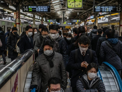 TOKYO, JAPAN - JANUARY 12: Commuters, mostly wearing face masks, pass through a train station as they travel to work during the first full week of Tokyos second state of emergency on January 12, 2021 in Tokyo, Japan. Tokyo and its surrounding prefectures remain under a month-long state of emergency …