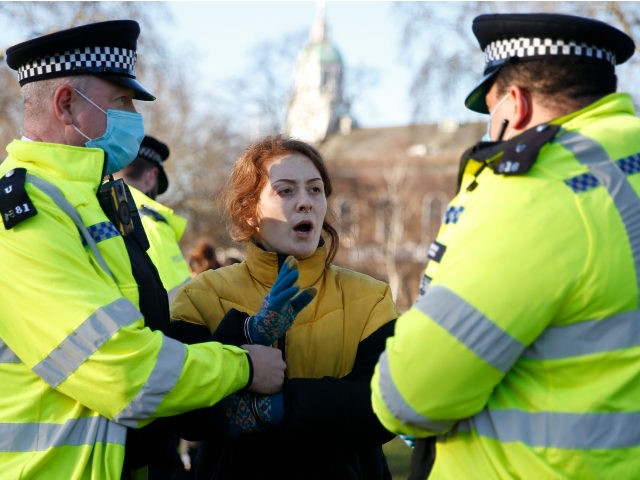 LONDON, ENGLAND - JANUARY 09: A protester is arrested by Police on Clapham Common during the anti-lockdown demonstration on January 9, 2021 in London, England. Chief Medical Officer Chris Whitty has filmed an advert for HM Government warning that people should stay home as the COVID-19 virus is spreading across …