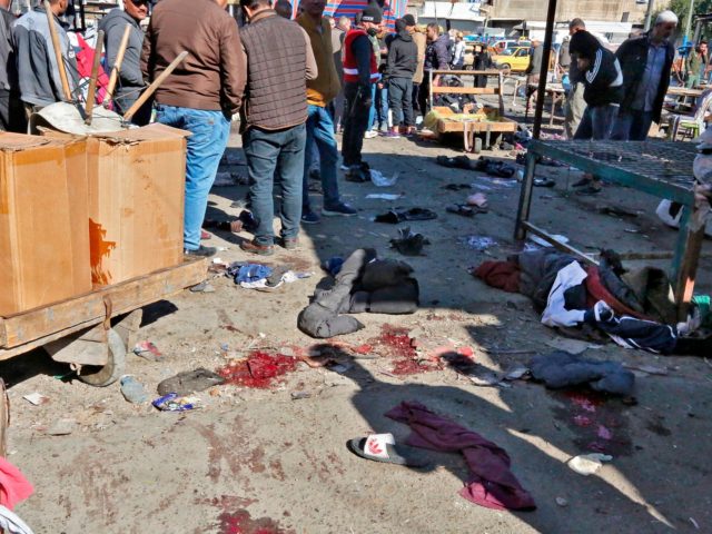 A picture shows the scene of a twin suicide bombing on a bustling commercial street in the heart of Baghdad on January 21, 2021. - The toll in a twin suicide bombing in an open-air Baghdad market morning topped 20 dead and 40 wounded, an interior ministry official told AFP. …