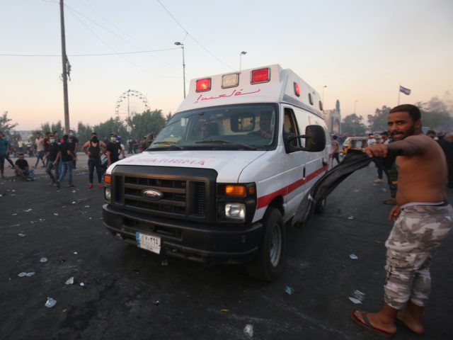 An ambulance arrives at a demonstration against state corruption, failing public services, and unemployment, in the Iraqi capital Baghdad on October 5, 2019. - Renewed protests took place under live fire in Iraq's capital and the country's south Saturday as the government struggled to agree a response to days of …