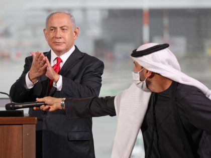 Israeli Prime Minister Benjamin Netanyahu (L) claps during a welcoming ceremony for the passengers of a flight operated by budget airline flydubai in Israel's Ben Gurion airport, near Tel Aviv, on November 26, 2020. - A flight operated by budget airline flydubai landed in Tel Aviv, the first scheduled commercial …