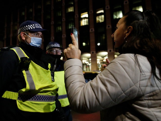 LONDON, ENGLAND - JANUARY 1: Met Police officers attempt to disperse crowds gathered near Westminster Bridge on January 1, 2021 in London, United Kingdom. New Year's Eve Celebrations have been curtailed in the UK this year dues to Coronavirus pandemic restrictions. With most of the UK in tiers three and …