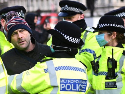 LONDON, ENGLAND - JANUARY 06: An anti-lockdown protester is held by police officers in Par