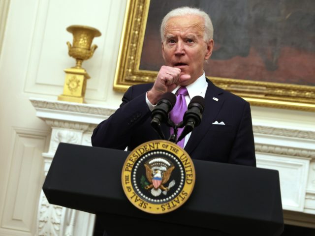 WASHINGTON, DC - JANUARY 21: U.S. President Joe Biden clears his throat as he speaks as Vice President Kamala Harris looks on during an event at the State Dining Room of the White House January 21, 2021 in Washington, DC. President Biden delivered remarks on his administration’s COVID-19 response, and …