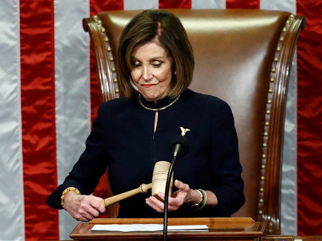 House Speaker Nancy Pelosi of Calif., holds the gavel after announcing the passage of the second article of impeachment, obstruction of Congress, against President Donald Trump by the House of Representatives at the Capitol in Washington, Wednesday, Dec. 18, 2019. (AP Photo/Patrick Semansky)