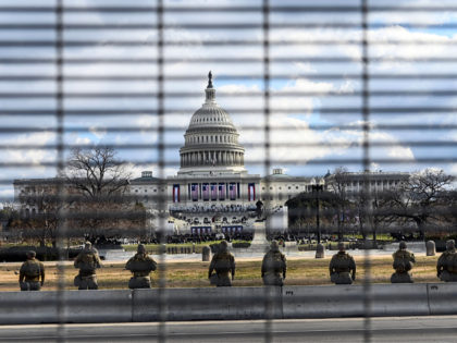 US National Guard troops stand in the vicinity of the US Capitol near high fences as the Inauguration of US President-Elect Joe Biden in Washington, DC begins on January 20, 2021. (Photo by ROBERTO SCHMIDT / AFP) (Photo by ROBERTO SCHMIDT/AFP via Getty Images)