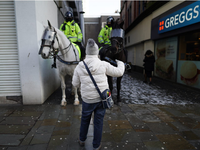 NEWCASTLE UPON TYNE, ENGLAND - JANUARY 09: An anti-lockdown protester remonstrates with mounted police officers in Newcastle city centre on January 09, 2021 in Newcastle upon Tyne, England. Chief Medical Officer Chris Whitty has filmed an advert for HM Government warning that people should stay home as the COVID-19 virus …