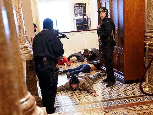 U.S. Capitol Police hold protesters at gun-point near the House Chamber inside the U.S. Ca