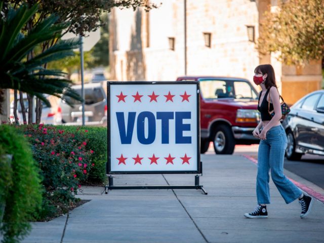 A voter walks toward a polling location on election day in Austin, Texas on November 3, 2020. - Americans were voting on Tuesday under the shadow of a surging coronavirus pandemic to decide whether to reelect Republican Donald Trump, one of the most polarizing presidents in US history, or send …