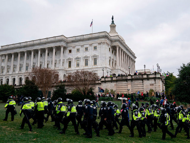 Riot police walk outside the US Capitol as supporters of US President Donald Trump protest