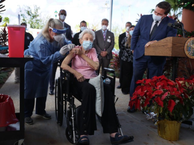 Florida Gov. Ron DeSantis (R) looks on as Vera Leip, 88, receives a Pfizer-BioNtech COVID-19 vaccine from Christine Philips, RN Florida Department of Health in Broward County, at the John Knox Village Continuing Care Retirement Community on December 16, 2020 in Pompano Beach, Florida. The facility, one of the first …