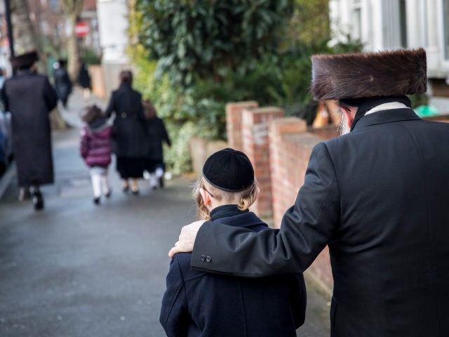 LONDON, ENGLAND - JANUARY 17: Members of the Jewish community walk along the street in the Stamford Hill area on January 17, 2015 in London, England. Police have announced they will increase patrols in areas with large Jewish communities such as London and Manchester in response to last week's Paris …