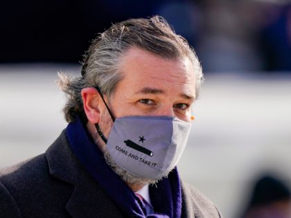 WASHINGTON, DC - JANUARY 20: Sen. Ted Cruz (C) (R-TX), wearing a face mask that reads "Com