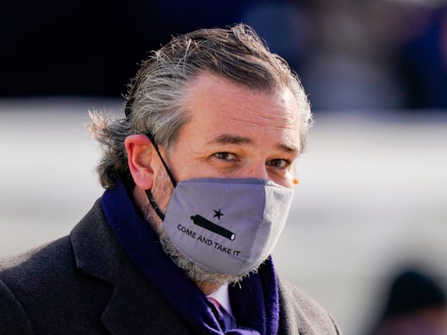 WASHINGTON, DC - JANUARY 20: Sen. Ted Cruz (C) (R-TX), wearing a face mask that reads &quot;Come and Take It&quot;, arrives to the inauguration of U.S. President-elect Joe Biden on the West Front of the U.S. Capitol on January 20, 2021 in Washington, DC. During todays inauguration ceremony Joe Biden …