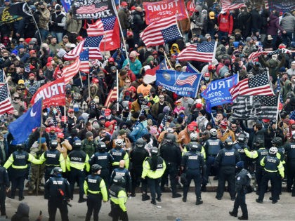 Trump supporters clash with police and security forces as they storm the US Capitol in Washington, DC on January 6, 2021. - Donald Trump's supporters stormed a session of Congress held today, January 6, to certify Joe Biden's election win, triggering unprecedented chaos and violence at the heart of American …
