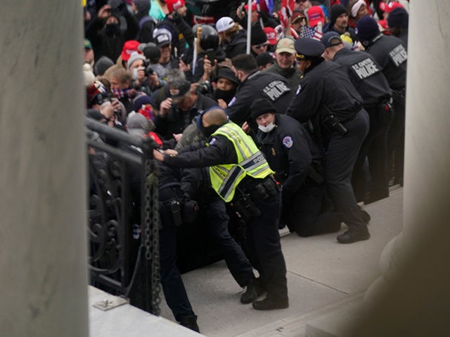 U.S. Capitol Police try to hold back protesters outside the U.S. Capitol, Wednesday, Jan 6