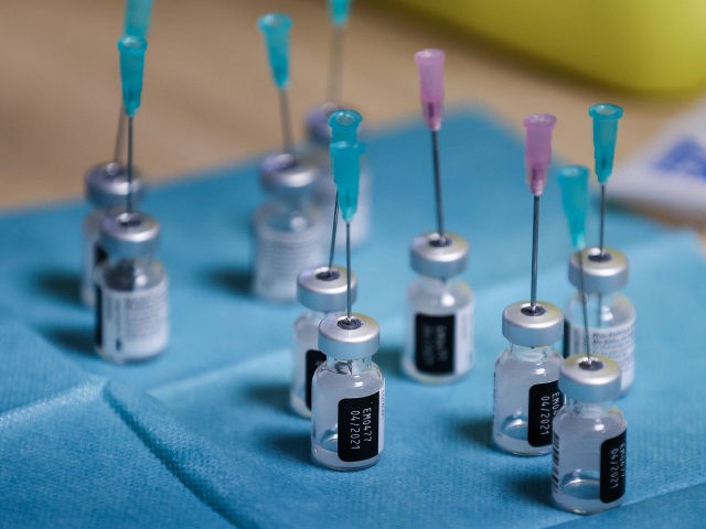 Doses of Pfizer-BioNTech Covid-19 vaccine are prepared for injection on January 14, 2021 at the Christalain nursing home in Brussels with a syringe and a needle that allow one extra dose of vaccine per vial. - EU's medicines watchdog said on January 8, 2021 that six doses instead of five …