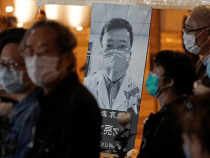 In this Feb. 7, 2020, file photo, people wearing masks attend a vigil for Chinese doctor Li Wenliang, who was reprimanded for warning about the outbreak of the new coronavirus, in Hong Kong. China has taken the highly unusual move of exonerating the doctor who was reprimanded for warning about …