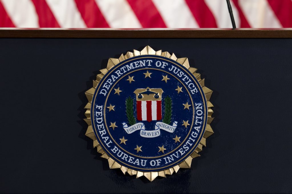 In this June 14, 2018, file photo, the FBI seal is seen before a news conference at FBI headquarters in Washington. A former FBI lawyer was sentenced to probation for altering a document the Justice Department relied on during its surveillance of a Donald Trump aide during the Russia investigation. (AP Photo/Jose Luis Magana, File)