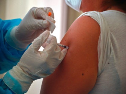 A woman is inoculated with the Pfizer vaccine against COVID-19 at the Pablo Arturo Suarez
