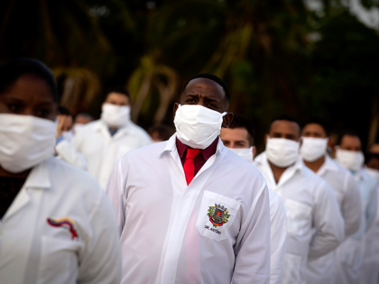 A brigade of health professionals, who volunteered to travel to South Africa to assist local authorities with an upsurge of coronavirus cases, attend the farewell ceremony in Havana, Cuba, Saturday, April 25, 2020. (AP Photo/Ramon Espinosa)