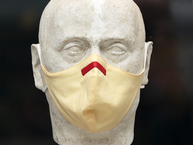 A men's clothing store mannequin has a mask, Thursday, Sept. 24, 2020 in New York. (AP Photo/Mark Lennihan)