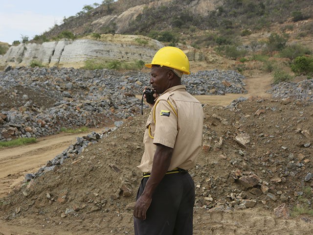 A security guard is seen near the sight of an abandoned mine where artisanal miners are tr
