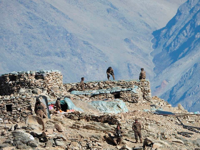 This photograph provided by the Indian Army, according to them shows Chinese troops dismantling their bunkers at Pangong Tso region, in Ladakh along the India-China border on Monday, Feb.15, 2021. China and India are pulling back front-line troops from disputed portions of their mountain border where they have been in a standoff for months. Both countries say the troops began the disengagement on Wednesday at the southern and northern banks of Pangong Lake in the Ladakh region. (Indian Army via AP)