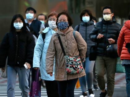 People wear face masks to help curb the spread of the coronavirus in Taipei, Taiwan, Thursday, Feb, 18, 2021. (AP Photo/Chiang Ying-ying)