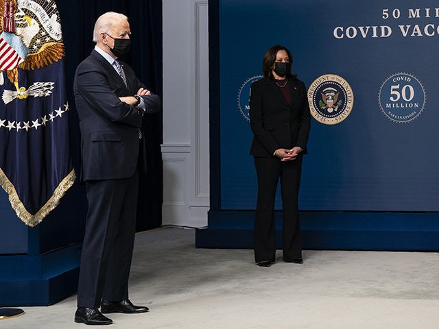 President Joe Biden looks on as Washington DC firefighter and EMT Gerald Burn receives a vaccination, during an event to commemorate the 50 millionth COVID-19 shot, in the South Court Auditorium on the White House campus, Thursday, Feb. 25, 2021, in Washington. From left, Biden, Vice President Kamala Harris, White …