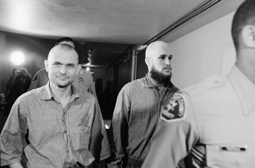 Charles Manson, not shown, and four members of his former family, Bruce Davis, left, and Steve Grogan, right appeared at Los Angeles Court for hearings in two murder cases, Tuesday, April 13, 1971, Los Angeles, Calif. (AP Photo/Wally Fong)