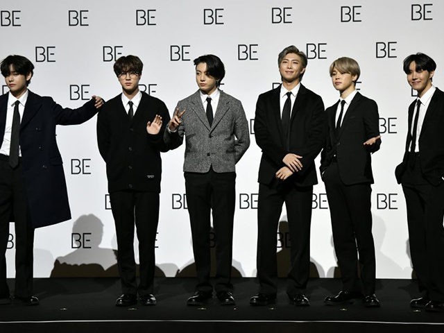South Korean K-pop boy band BTS members (L to R) V, Jin, Jung Kook, RM, Jimin and J-Hope pose for a photo session during a press conference on BTS new album 'BE (Deluxe Edition)' in Seoul on November 20, 2020. (Photo by Jung Yeon-je / AFP) (Photo by JUNG YEON-JE/AFP …