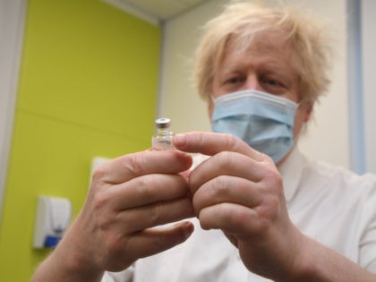 LONDON, ENGLAND - FEBRUARY 15: Prime Minister Boris Johnson gestures as he visits a coronavirus vaccination centre at the Health and Well-being Centre in Orpington, south-east London on February 14, 2021 in London, England. The visit coincides with the country surpassing 15 million people who have received at least one …