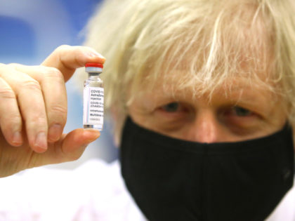 CWMBRAN, WALES – FEBRUARY 17: British Prime Minister Boris Johnson poses with a vial of the Oxford/AstraZeneca vaccine during a visit to the vaccination centre at Cwmbran Stadium on February 17, 2021 in Cwmbran, Wales. The Prime Minister visited the vaccination centre to see the progress of the COVID-19 vaccine …