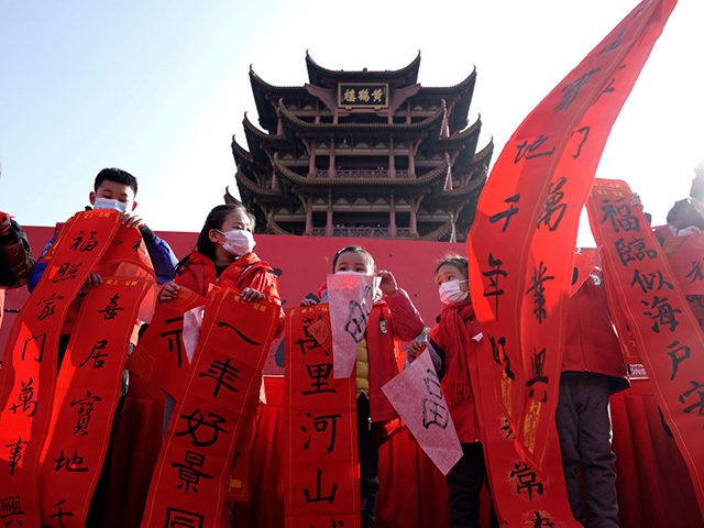 WUHAN, CHINA - JANUARY 01: (CHINA OUT) Children show their calligraphy during New Year celebrations at Yellow Crane Tower Park on January 1, 2021 in Wuhan, Hubei Province, China. Wuhan has no recorded COVID-19 cases of community transmissions since May 2020, life for residents is gradually returning to normal. (Photo …