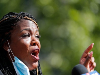 Activist Cori Bush speaks during a news conference Wednesday, Aug. 5, 2020, in St. Louis. Bush pulled a political upset on Tuesday, beating 20-year incumbent Rep. William Lacy Clay in Missouri's 1st District Democratic primary. (AP Photo/Jeff Roberson)