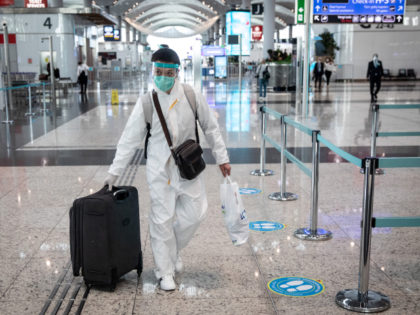 ISTANBUL, TURKEY - JUNE 01: A passenger wearing protective equipment wheels his luggage to a check-in counter at Istanbul Airport on June 01, 2020 in Istanbul, Turkey. As infection rates of the coronavirus continue to drop and after more than a month of weekend lockdowns, Turkey has begun reopening procedures, …