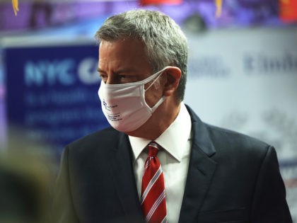 New York City Mayor Bill de Blasio wears two masks as he helps distribute food in Queens o