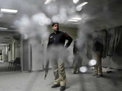 Pakistani policemen search a hospital following the gunmen attack at the Jinnah Hospital i