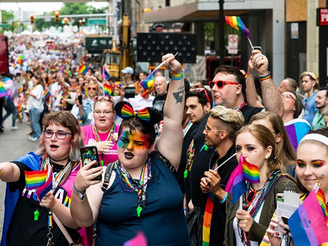 DETROIT, MI - JUNE 09: Locals and onlookers shout and wave rainbow flags during the Motor City Pride Parade on June 9, 2019 in Detroit, Michigan. (Photo by Brittany Greeson/Getty Images)